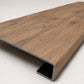 Custom square nose stair tread made with A&A Surfaces Forrest Brown flooring, featuring a continuous wood-look surface for a clean, professional stair update. Angled View