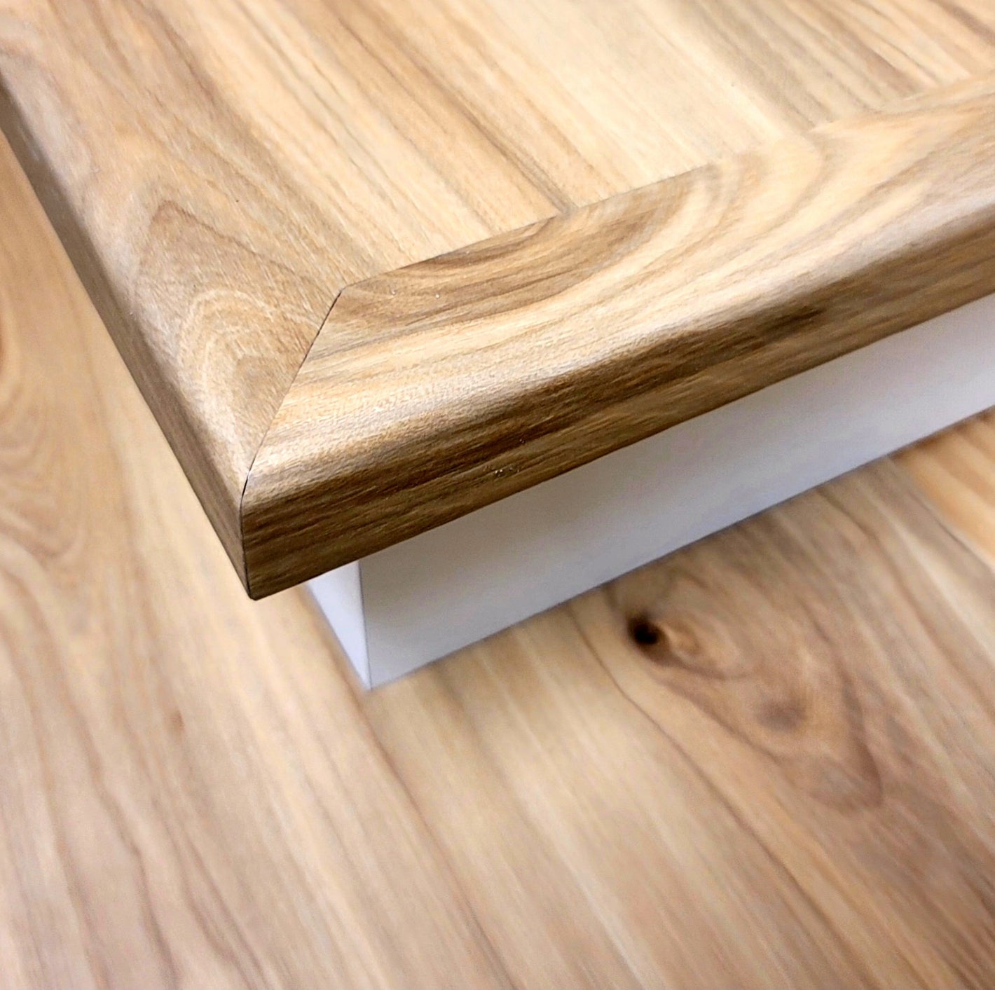 Custom vinyl stair tread with an open end and flush stair nosing, professionally installed for a clean, finished edge on an open staircase.