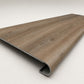 Custom round-nose stair tread made from DuraLux Performance Alamo Oak flooring. Round profile. Angled view