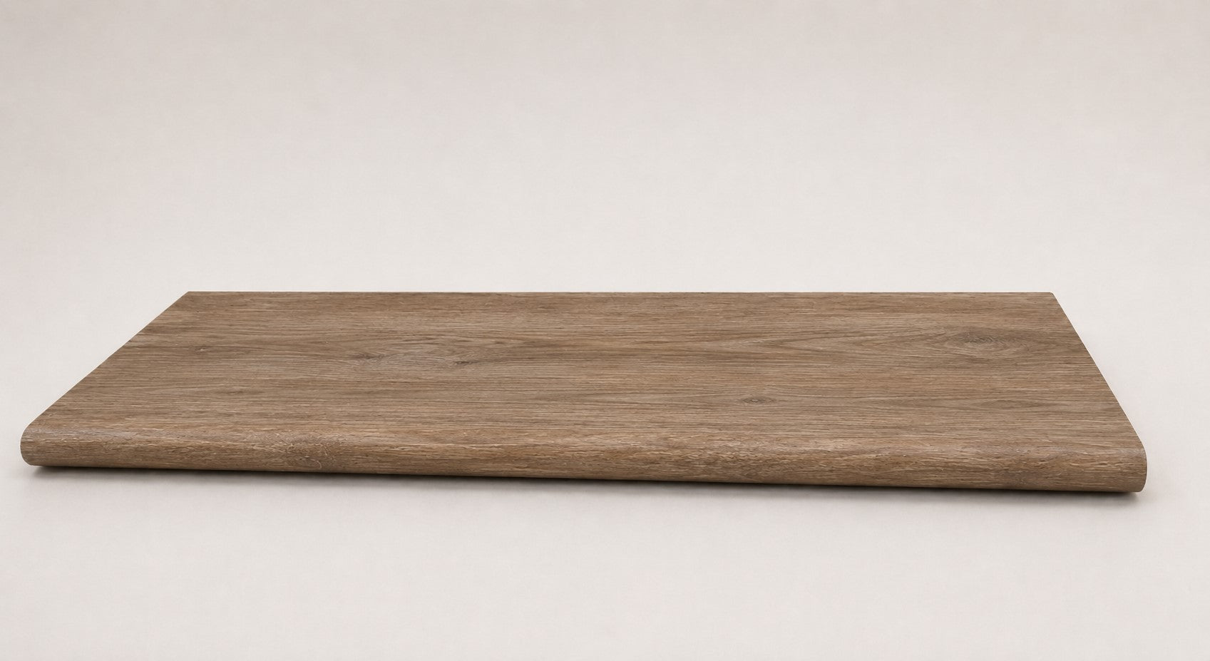 Custom round-nose stair tread made from DuraLux Performance Alamo Oak flooring. Round profile. Full view.
