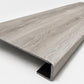 Custom square-nose stair tread made from DuraLux Performance Highguard Silver flooring. Square profile. Angled view.