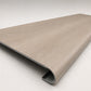 Custom round-nose stair tread made from DuraLux Performance Lorraine Sienna flooring. Round profile. Angled view.