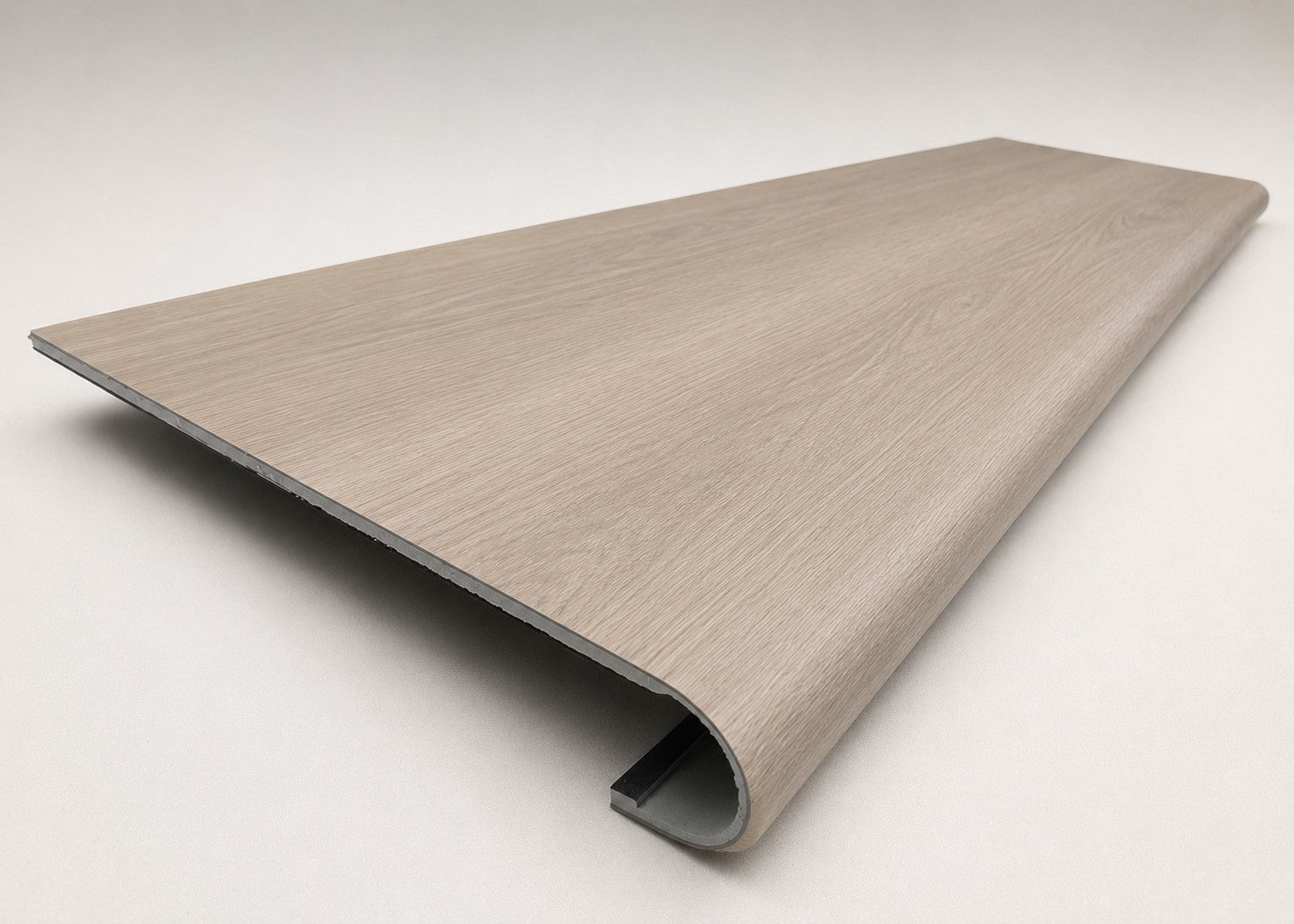 Custom round-nose stair tread made from DuraLux Performance Lorraine Sienna flooring. Round profile. Angled view.