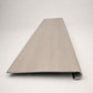 Custom round-nose stair tread made from DuraLux Performance Lorraine Sienna flooring. Round profile. Front view.