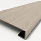 Custom square-nose stair tread made from DuraLux Performance Lorraine Sienna flooring. Square profile. Angled view.
