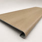 Custom round-nose stair tread made from DuraLux Performance Paisley Cape flooring. Round profile. Angled view.