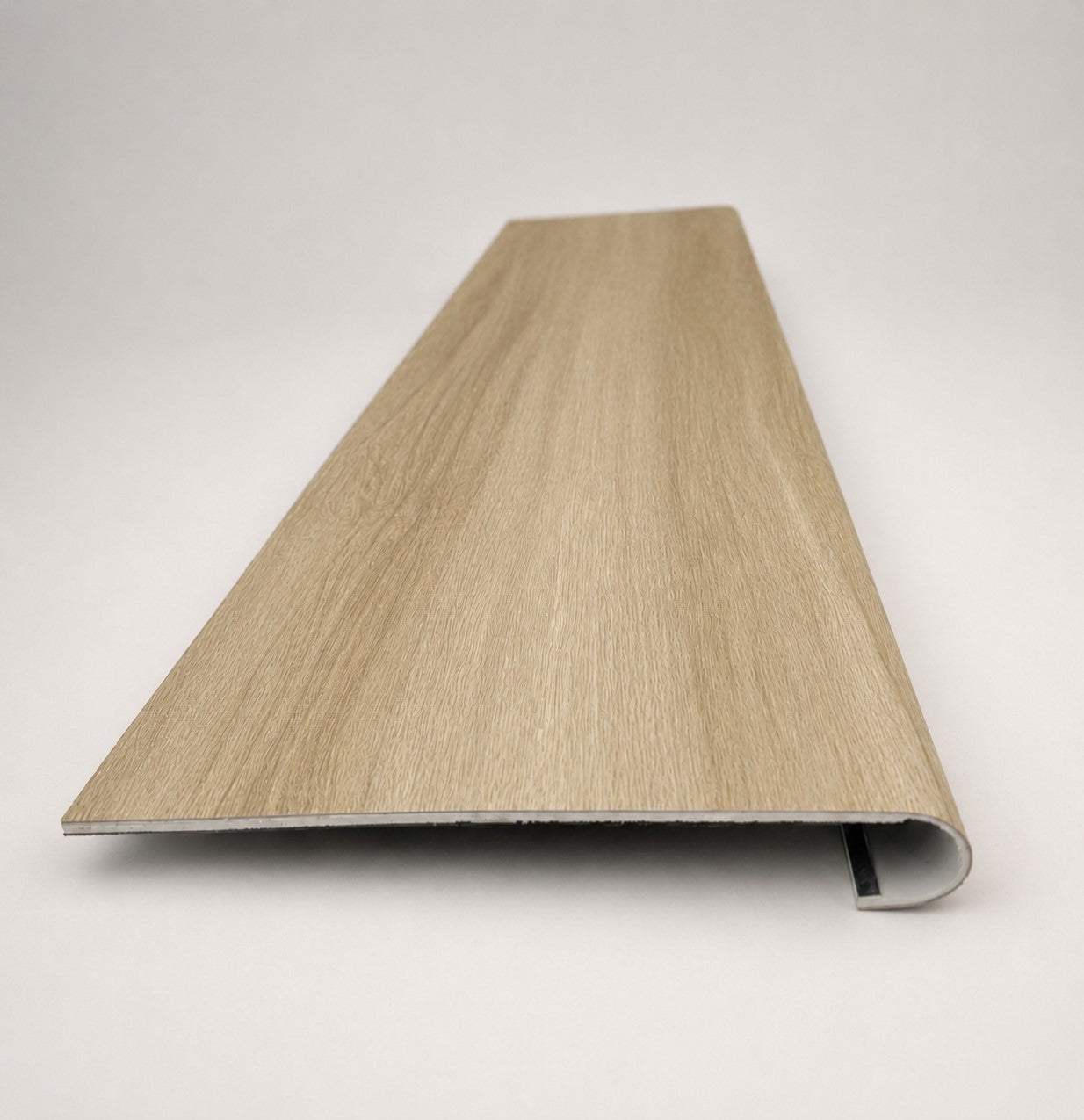 Custom round-nose stair tread made from DuraLux Performance Paisley Cape flooring. Round profile. Front view.