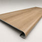 Custom round-nose stair tread made from DuraLux Performance Piedmont Bend flooring. Round profile. Angled view.
