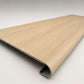 Custom round-nose stair tread made from DuraLux Performance Poplar Trace flooring. Round profile. Angled view.
