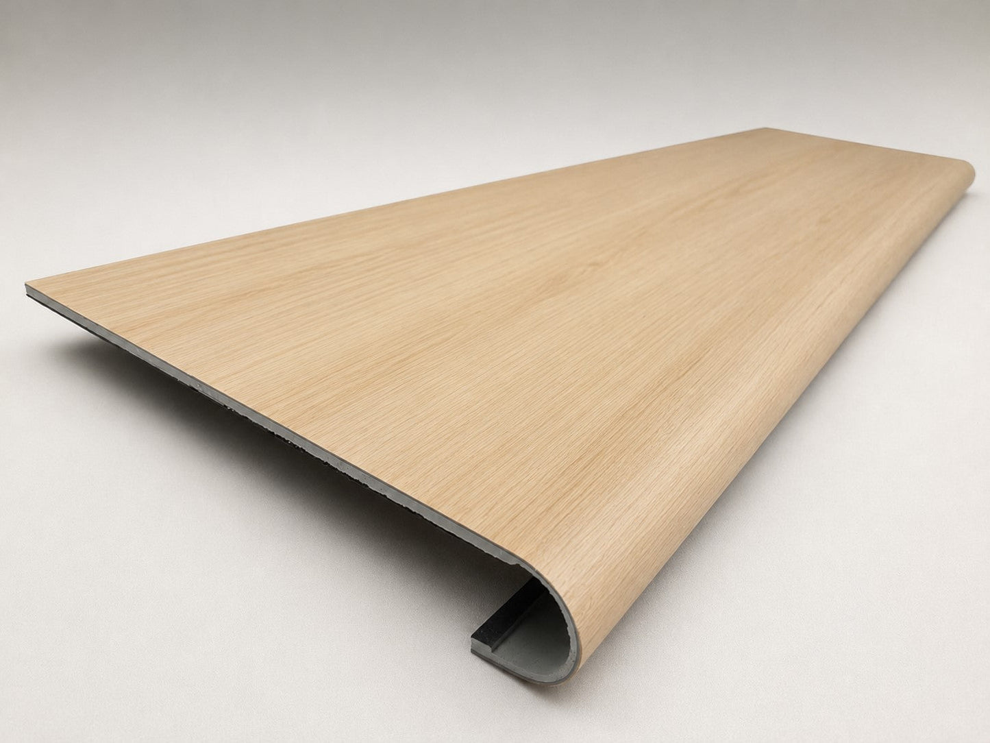 Custom round-nose stair tread made from DuraLux Performance Poplar Trace flooring. Round profile. Angled view.