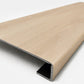 Custom square-nose stair tread made from DuraLux Performance Poplar Trace flooring. Square profile. Angled view.