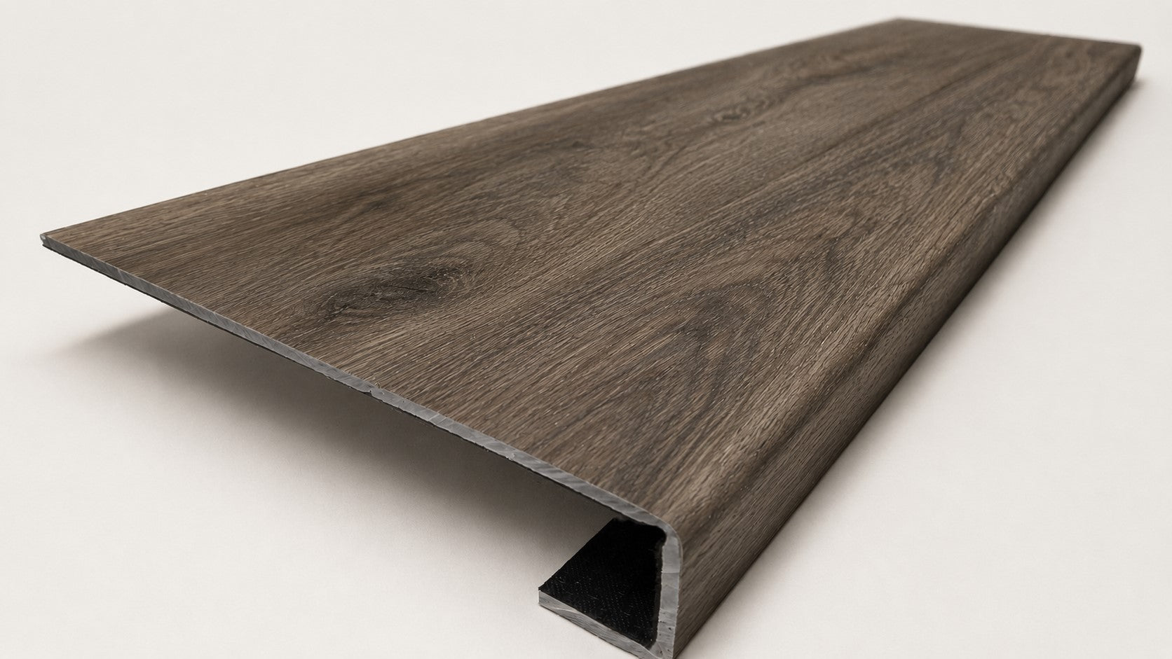 Custom square-nose stair tread made from DuraLux Performance Stormy Elm flooring. Square profile. Angled view.