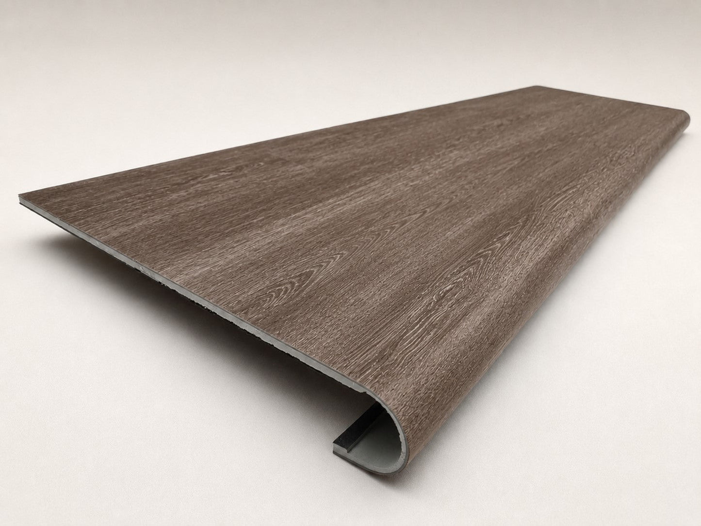 Custom round-nose stair tread made from DuraLux Performance Winter Peak flooring. Round profile. Angled view.