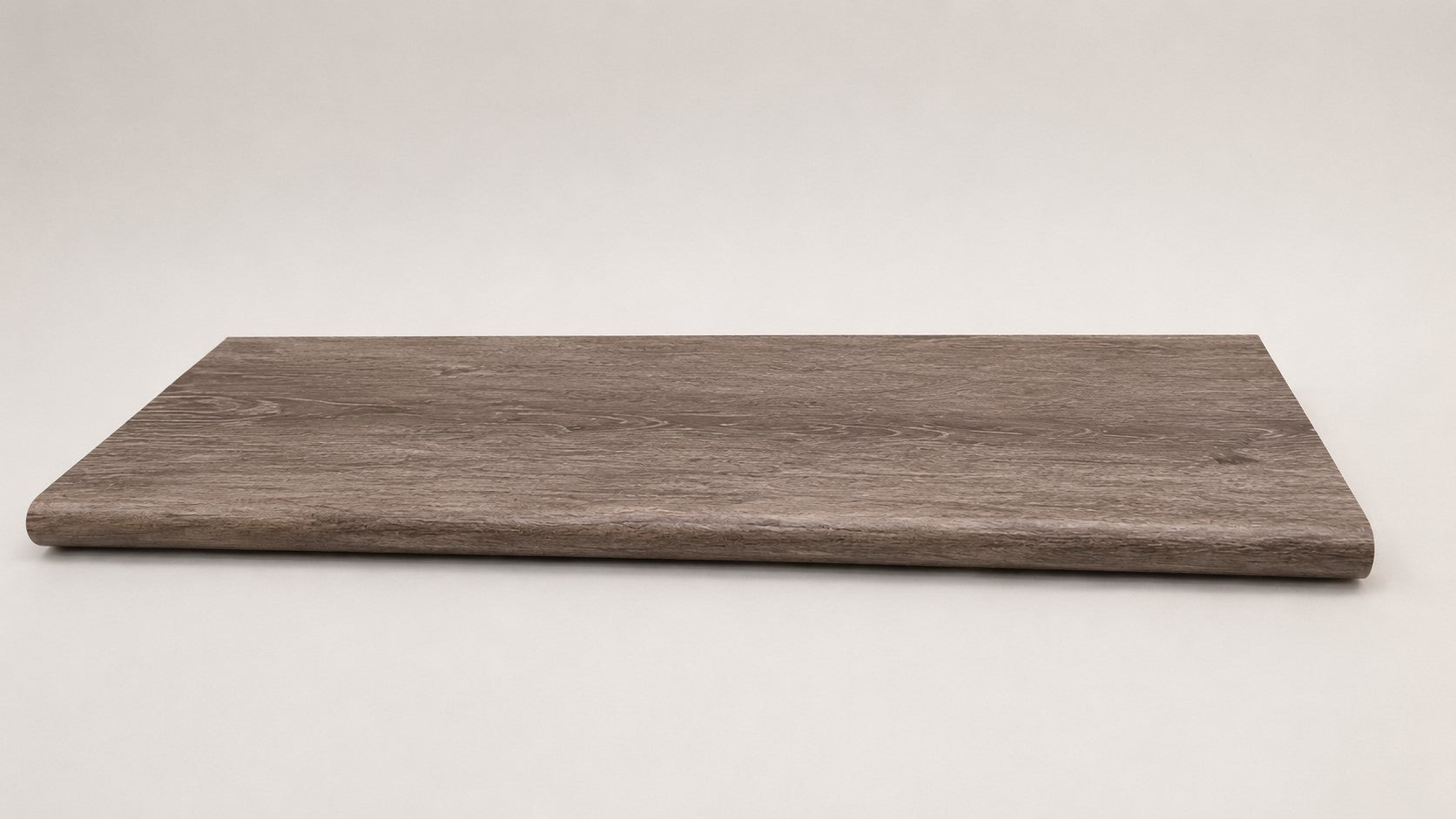 Custom round-nose stair tread made from DuraLux Performance Winter Peak flooring. Round profile. Full view.
