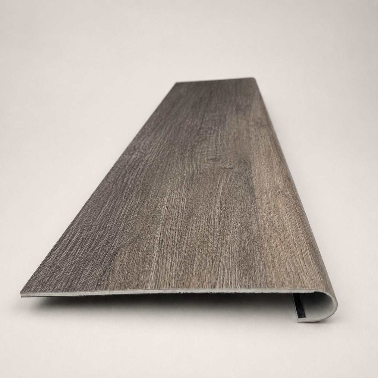 Custom round-nose stair tread made to match LifeProof Bradbury Hill flooring, with a weathered wood-look finish, continuous grain, and a smooth rounded profile for a finished stair edge. Front View
