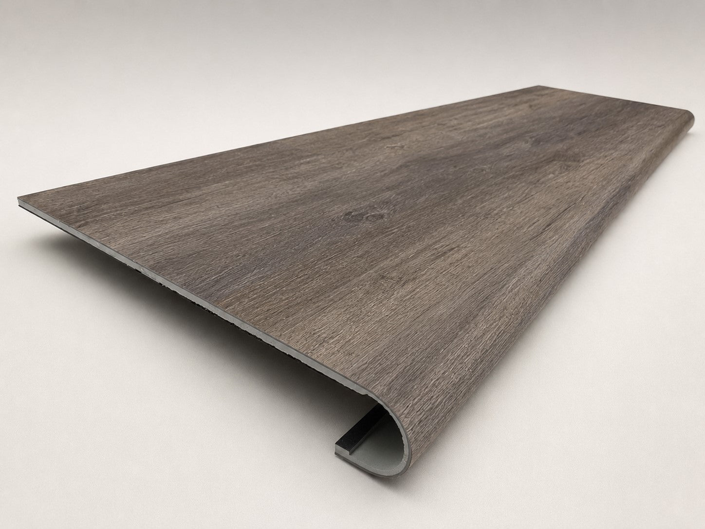 Custom round-nose stair tread made to match LifeProof Bradbury Hill flooring, with a weathered wood-look finish, continuous grain, and a smooth rounded profile for a finished stair edge. Angled View