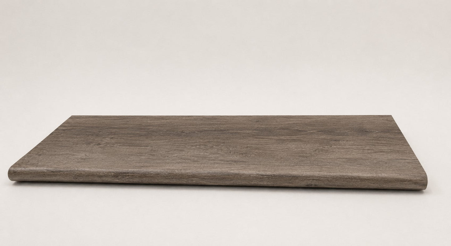 Custom round-nose stair tread made to match LifeProof Bradbury Hill flooring, with a weathered wood-look finish, continuous grain, and a smooth rounded profile for a finished stair edge. Front View