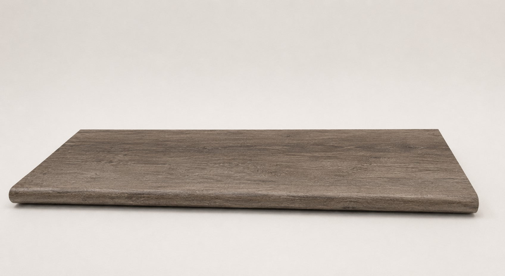 Custom round-nose stair tread made to match LifeProof Bradbury Hill flooring, with a weathered wood-look finish, continuous grain, and a smooth rounded profile for a finished stair edge. Front View