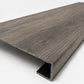 Custom square-nose stair tread made to match LifeProof Bradbury Hill flooring, with a weathered wood-look finish, continuous grain, and a square profile for a finished stair edge. Angled View