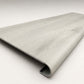 Custom round-nose stair tread made from LifeProof Chiffon Lace flooring. Round profile. Angled view.