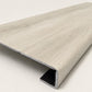 Custom square-nose stair tread made from LifeProof Chiffon Lace flooring. Square profile. Angled view.
