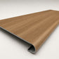 Custom round-nose stair tread made from LifeProof Clermont Elm flooring. Round profile. Angled view.