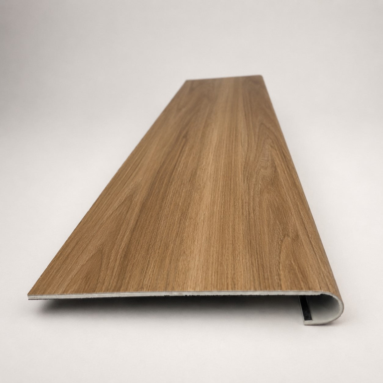 Custom round-nose stair tread made from LifeProof Clermont Elm flooring. Round profile. Front view.