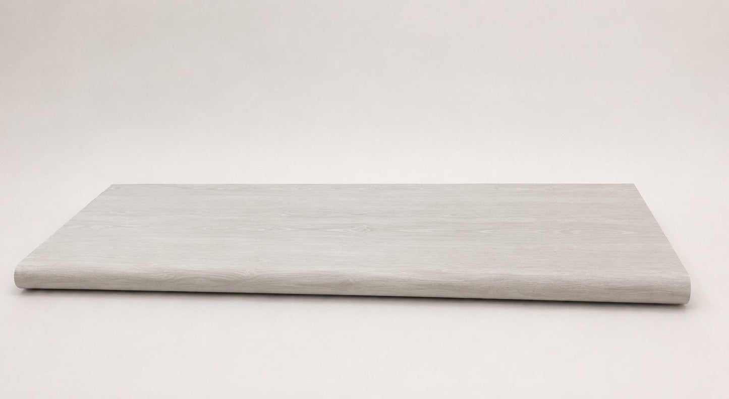 Custom round-nose stair tread made from LifeProof Driftwood Beach Oak flooring. Round profile. Full view.