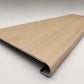 Custom round-nose stair tread made from LifeProof Dusk Cherry flooring. Round profile. Angled view.