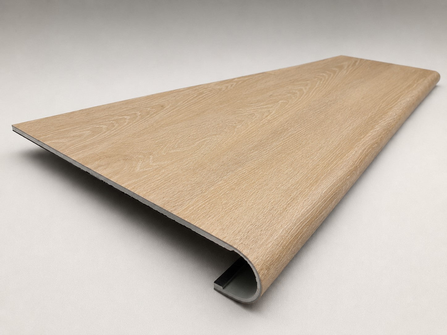 Custom round-nose stair tread made from LifeProof Dusk Cherry flooring. Round profile. Angled view.