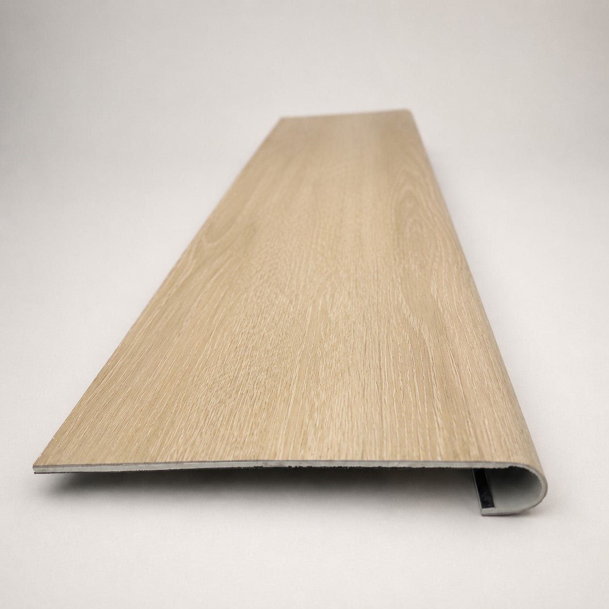 Custom round-nose stair tread made from LifeProof Dusk Cherry flooring. Round profile. Front view.