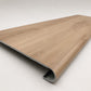 Custom round-nose stair tread made from LifeProof Fresh Oak flooring. Round profile. Angled view.