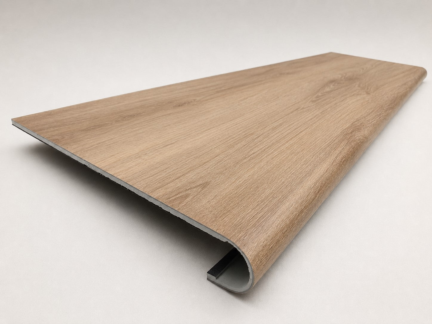 Custom round-nose stair tread made from LifeProof Fresh Oak flooring. Round profile. Angled view.