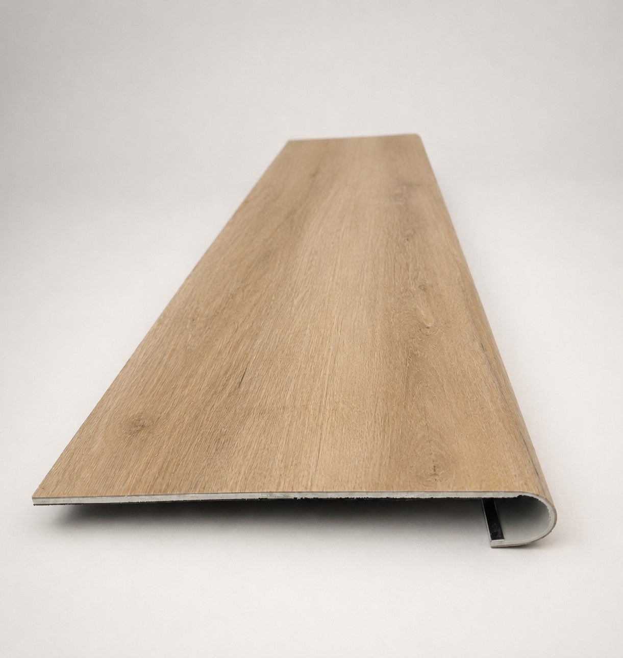 Custom round-nose stair tread made from LifeProof Fresh Oak flooring. Round profile. Front view.