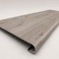 Custom round-nose stair tread made from LifeProof Kacee Canyon Oak flooring. Round profile. Angled view.