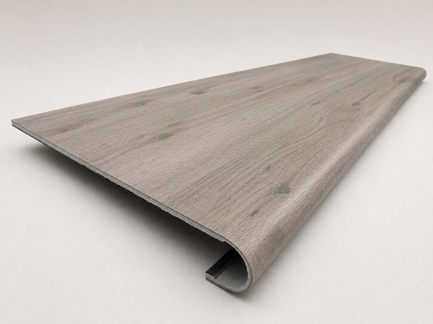 Custom round-nose stair tread made from LifeProof Kacee Canyon Oak flooring. Round profile. Angled view.