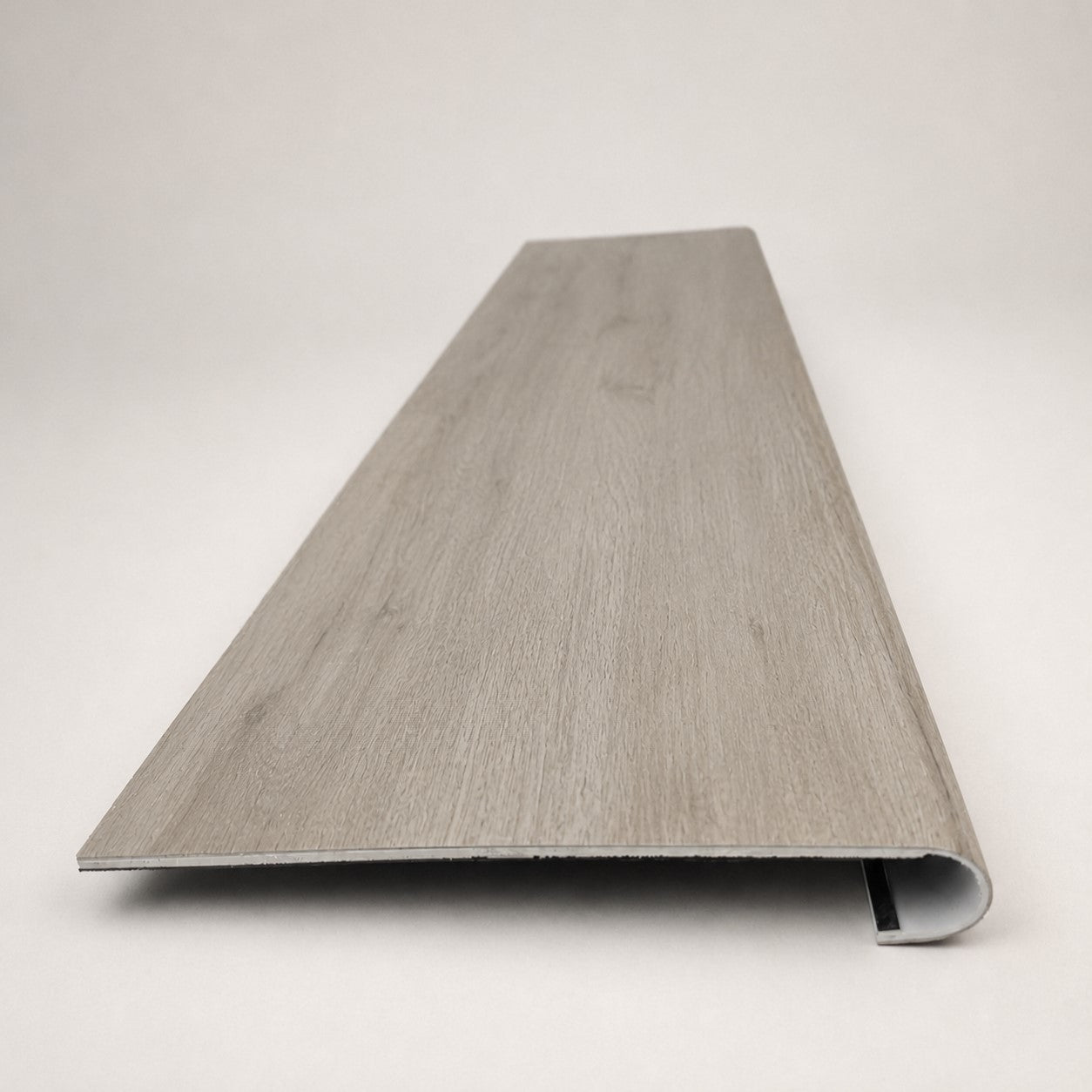Custom round-nose stair tread made from LifeProof Kacee Canyon Oak flooring. Round profile. Front view.