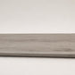 Custom round-nose stair tread made from LifeProof Kacee Canyon Oak flooring. Round profile. Angled view.