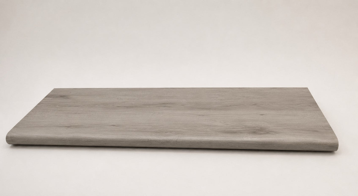 Custom round-nose stair tread made from LifeProof Kacee Canyon Oak flooring. Round profile. Angled view.