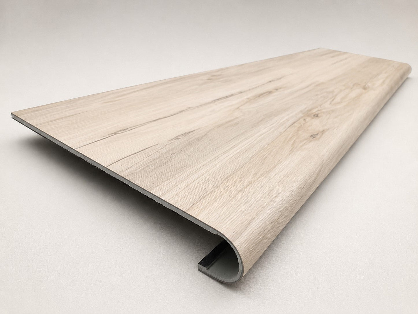 Custom round-nose stair tread made from LifeProof Navarra Maple Oak flooring. Round profile. Angled view.