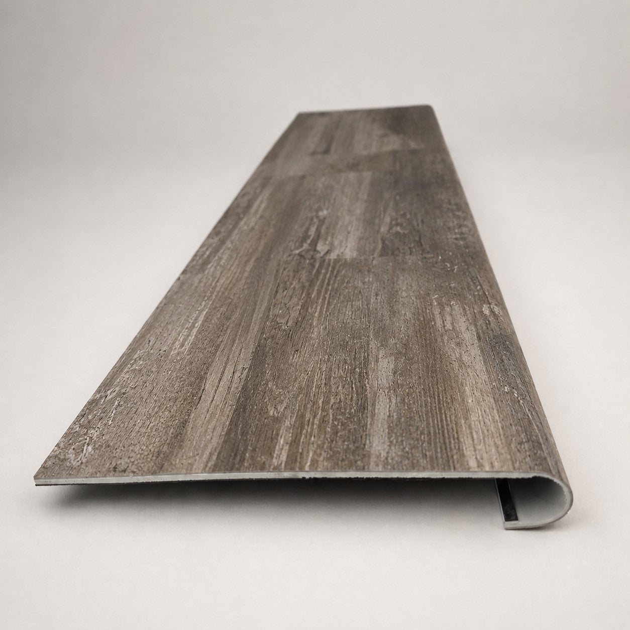 Custom round-nose stair tread made to match LifeProof Restored Wood flooring. Round profile. Front view.