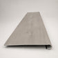 Custom round-nose stair tread made from LifeProof Sterling Oak flooring. Round profile. Front view.