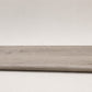 Custom round-nose stair tread made from LifeProof Sterling Oak flooring. Round profile. Full view.