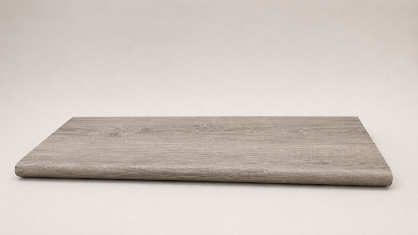 Custom round-nose stair tread made from LifeProof Sterling Oak flooring. Round profile. Full view.