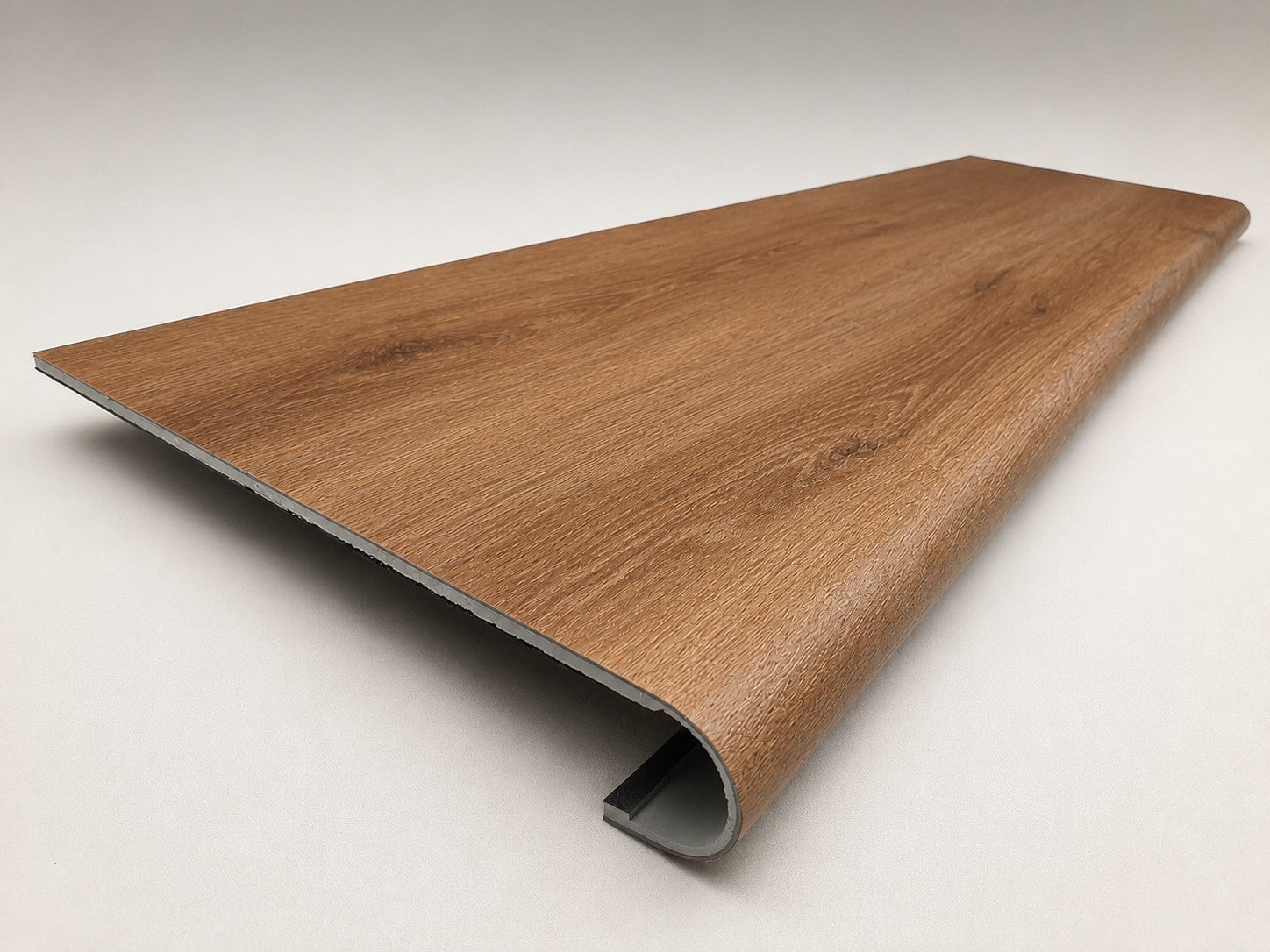 Custom round-nose stair tread made from LifeProof Trail Oak flooring. Round profile. Angled view.