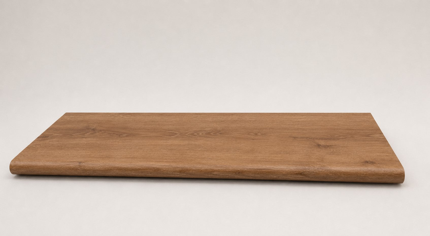 Custom round-nose stair tread made from LifeProof Trail Oak flooring. Round profile. Full view.