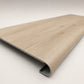 Custom round-nose stair tread made to match LifeProof Vesinet Oak flooring, featuring a light wood-look finish, continuous grain, and a smooth rounded profile for a clean stair transition. Angled View