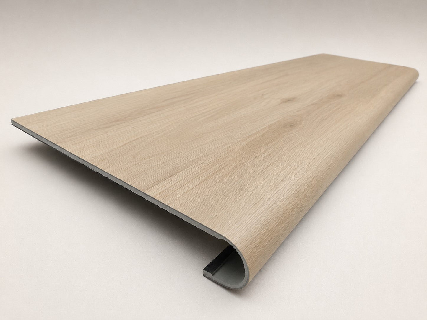 Custom round-nose stair tread made to match LifeProof Vesinet Oak flooring, featuring a light wood-look finish, continuous grain, and a smooth rounded profile for a clean stair transition. Angled View