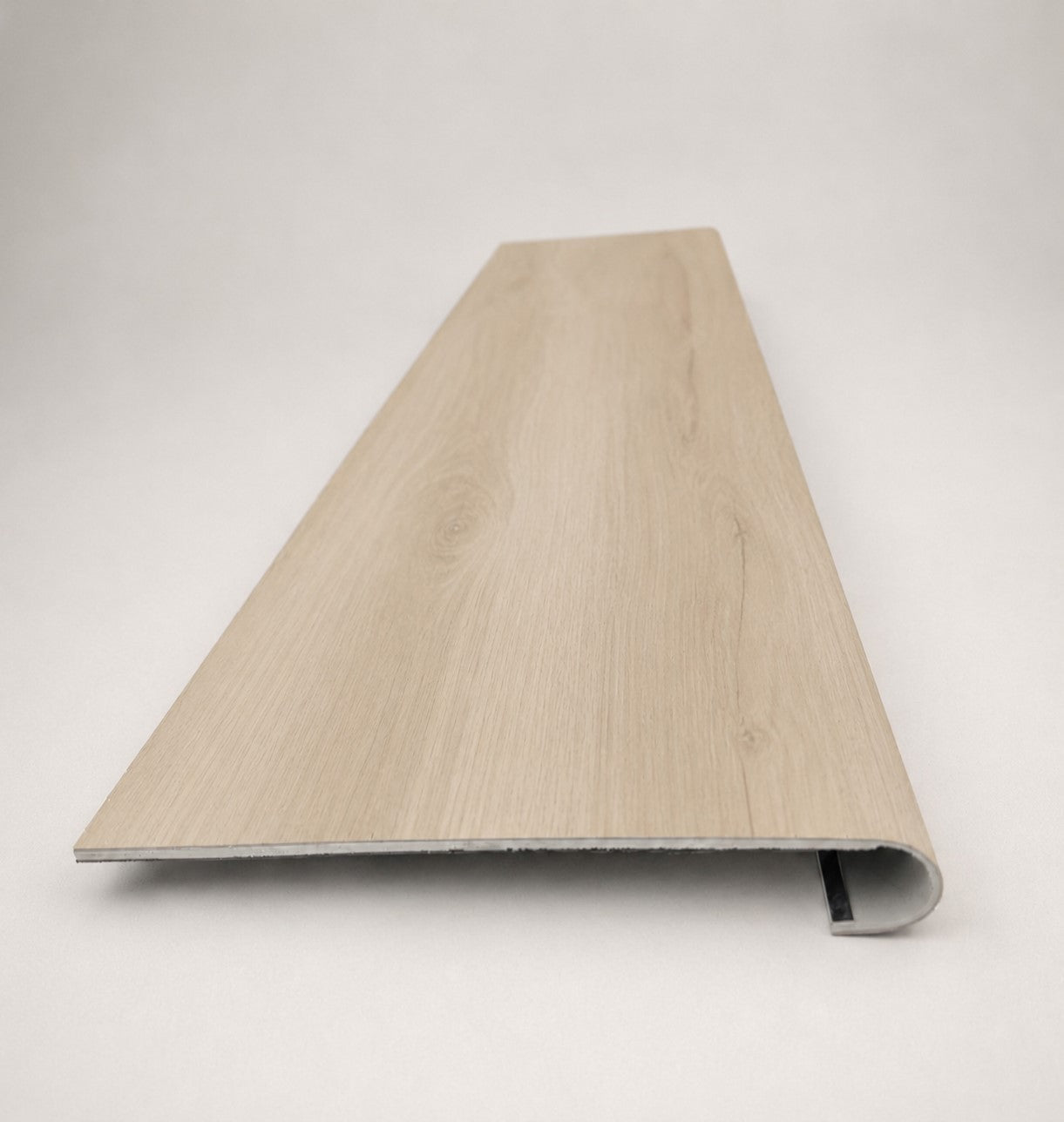 Custom round-nose stair tread made to match LifeProof Vesinet Oak flooring, featuring a light wood-look finish, continuous grain, and a smooth rounded profile for a clean stair transition. Front View