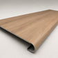 Custom round-nose stair tread made to match LifeProof Westminster Oak flooring. Round profile. Angled view.